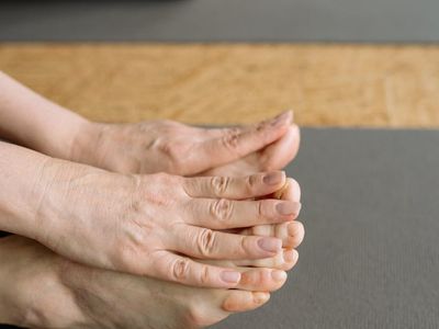 Close-up of feet on a yoga mat showing balance.